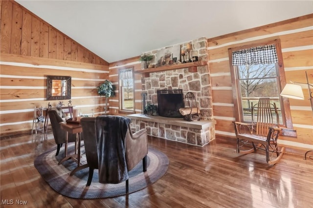1525 Old Kyle Rd, Dorset, OH 44032 - living room with lofted ceiling, wooden walls, wood finished floors, and a fireplace
