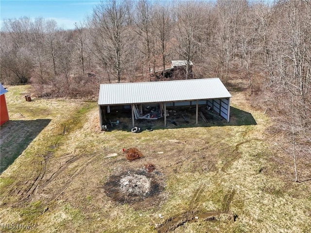 1525 Old Kyle Rd, Dorset, OH 44032 - exterior space with metal roof, an outdoor structure, a pole building, and a wooded view