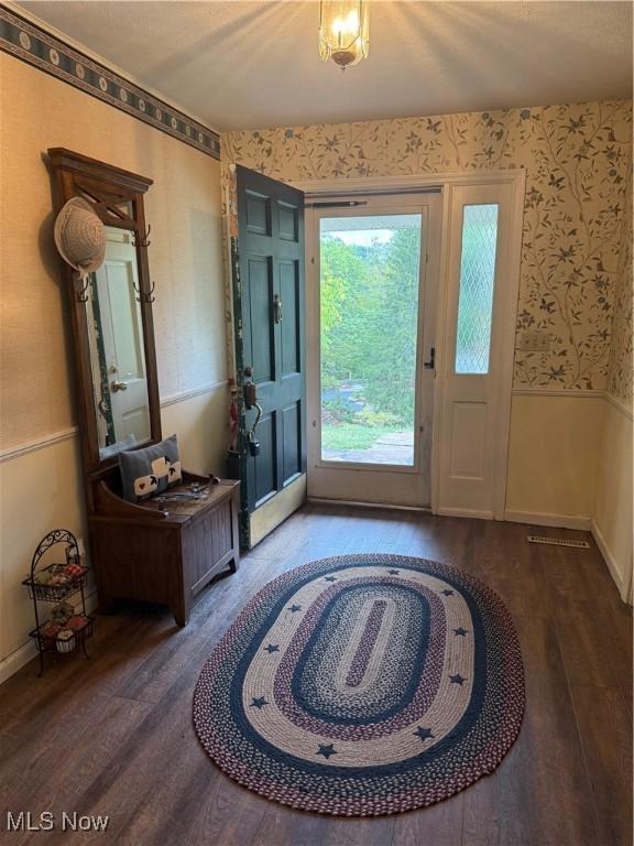 106 Wildwood Dr, Marietta, OH 45750 - entrance foyer featuring wallpapered walls, wood finished floors, and a wainscoted wall