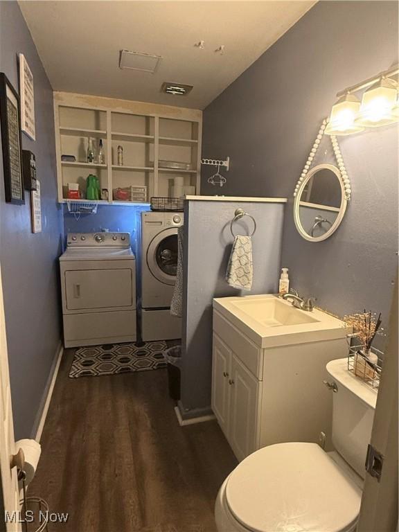 106 Wildwood Dr, Marietta, OH 45750 - bathroom featuring wood finished floors, toilet, vanity, and separate washer and dryer