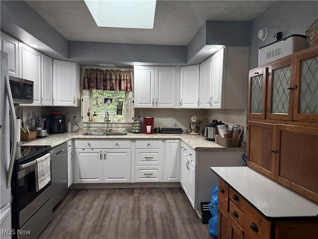 106 Wildwood Dr, Marietta, OH 45750 - kitchen featuring dark wood finished floors, decorative backsplash, white cabinets, and a sink