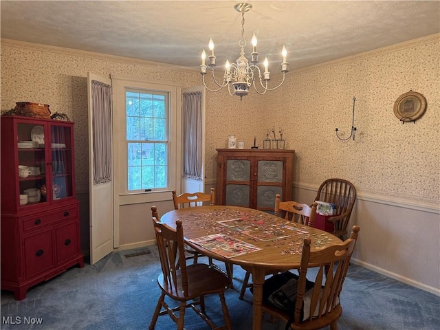 106 Wildwood Dr, Marietta, OH 45750 - carpeted dining space featuring a wainscoted wall, a notable chandelier, crown molding, and wallpapered walls