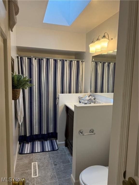 106 Wildwood Dr, Marietta, OH 45750 - bathroom with vanity, a skylight, toilet, and visible vents
