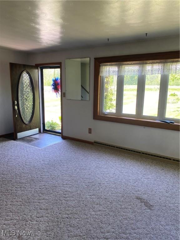 30173 Georgetown Rd, Salem, OH 44460 - foyer entrance with a baseboard heating unit, carpet floors, and baseboards