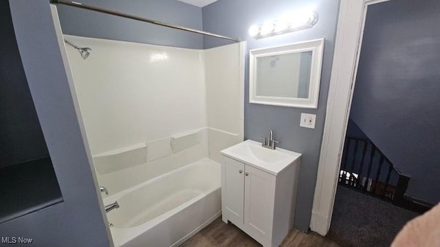 full bath featuring vanity,  shower combination, and wood finished floors