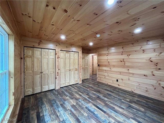 2239 Eureka Rd, Ashtabula, OH 44004 - unfurnished bedroom with recessed lighting, multiple closets, dark wood-style floors, and wooden walls