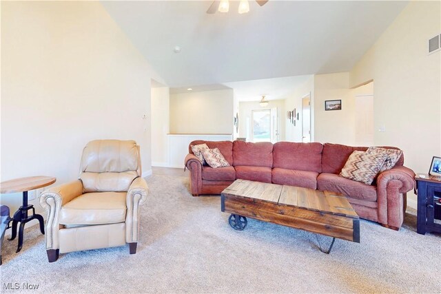 living area with visible vents, high vaulted ceiling, a ceiling fan, and carpet floors