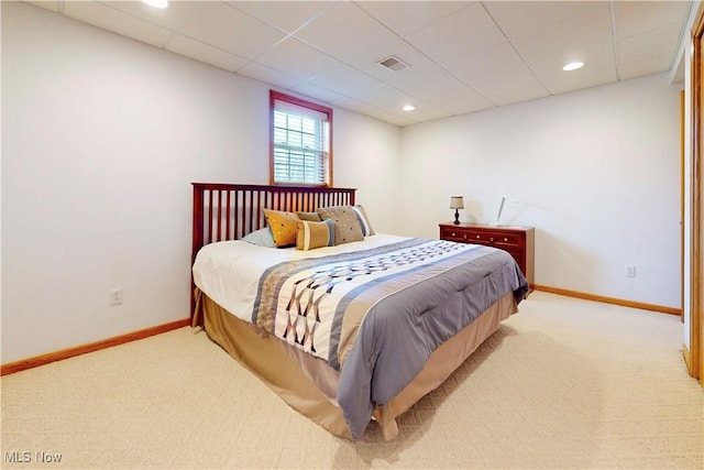 carpeted bedroom with recessed lighting, baseboards, visible vents, and a paneled ceiling