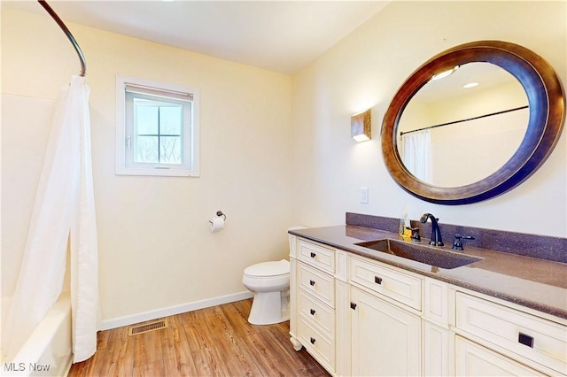 full bathroom with visible vents, toilet, wood finished floors, baseboards, and vanity