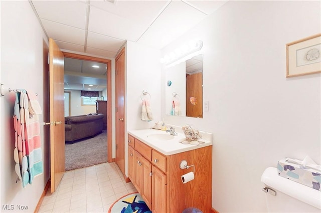 ensuite bathroom featuring vanity, toilet, a paneled ceiling, and ensuite bathroom