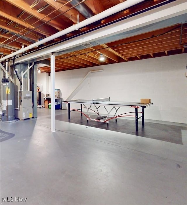 basement featuring heating unit and water heater