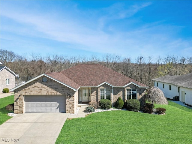 ranch-style house with an attached garage, a shingled roof, a front lawn, concrete driveway, and brick siding