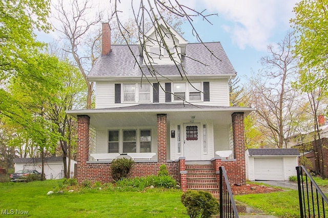 traditional style home with brick siding, a front yard, covered porch, a chimney, and an outdoor structure