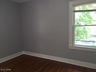 1033 Rushleigh Rd, Cleveland Heights, OH 44121 - unfurnished room with baseboards and dark wood-style flooring