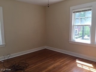 1033 Rushleigh Rd, Cleveland Heights, OH 44121 - empty room featuring dark wood-style floors and baseboards