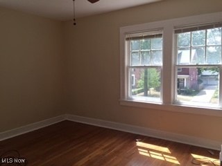 1033 Rushleigh Rd, Cleveland Heights, OH 44121 - empty room with a ceiling fan, dark wood-type flooring, and baseboards