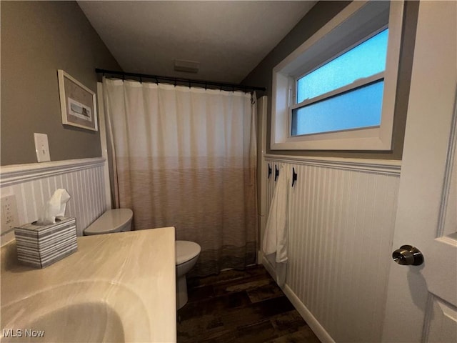 2326 Canfield Rd, Akron, OH 44312 - full bath with a wainscoted wall, toilet, a shower with shower curtain, wood finished floors, and vanity