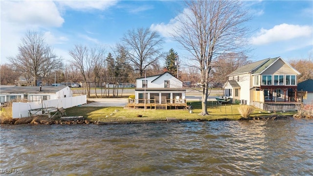 2326 Canfield Rd, Akron, OH 44312 - rear view of house with fence, a lawn, a water view, and a sunroom