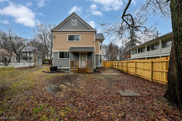 back of house with cooling unit and fence