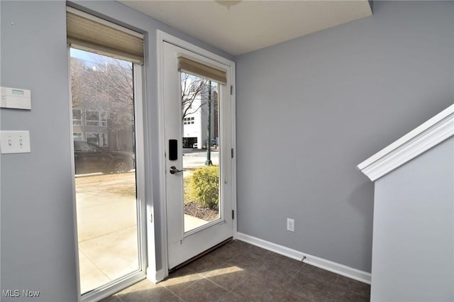 1261 W 74, Cleveland, OH 44102 - doorway to outside with baseboards and dark tile patterned floors