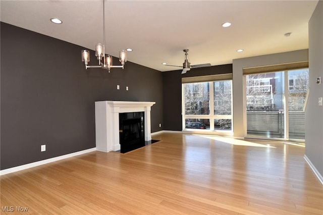 1261 W 74, Cleveland, OH 44102 - unfurnished living room featuring wood finished floors, ceiling fan, recessed lighting, a fireplace with flush hearth, and baseboards