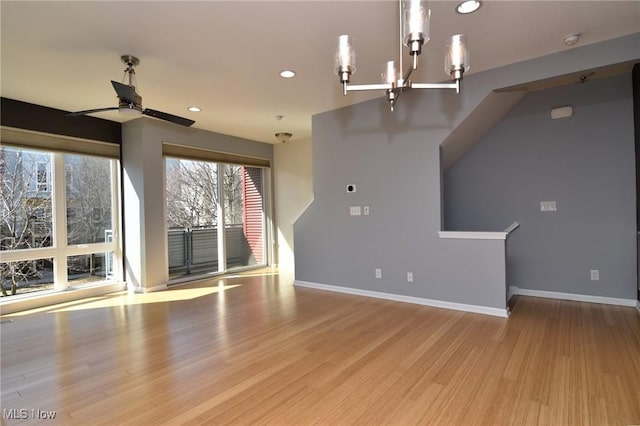 1261 W 74, Cleveland, OH 44102 - unfurnished living room with a chandelier, a ceiling fan, wood finished floors, recessed lighting, and baseboards