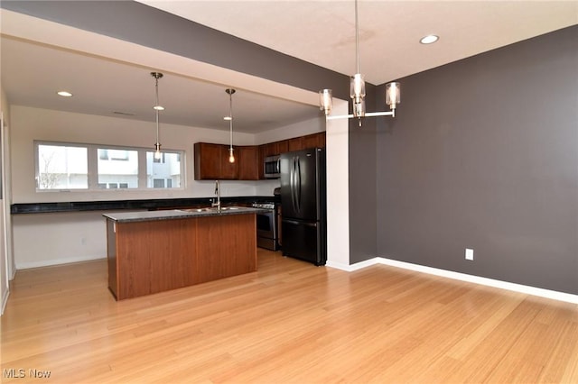 1261 W 74, Cleveland, OH 44102 - kitchen with appliances with stainless steel finishes, dark countertops, light wood-style floors, recessed lighting, and baseboards