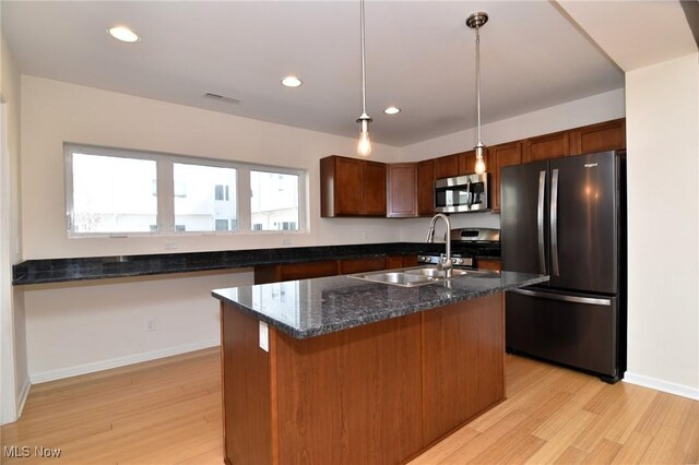 1261 W 74, Cleveland, OH 44102 - kitchen with freestanding refrigerator, stainless steel microwave, a sink, light wood-type flooring, and recessed lighting