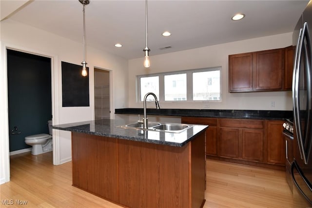 1261 W 74, Cleveland, OH 44102 - kitchen with a sink, freestanding refrigerator, light wood-style flooring, decorative light fixtures, and recessed lighting
