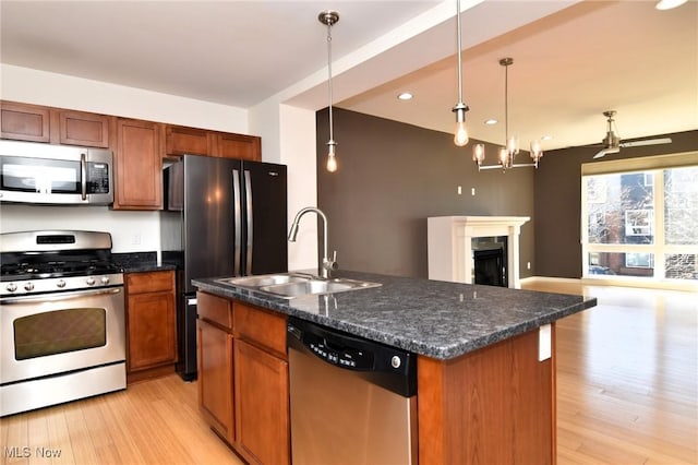1261 W 74, Cleveland, OH 44102 - kitchen with stainless steel appliances, a sink, open floor plan, light wood-type flooring, and an island with sink
