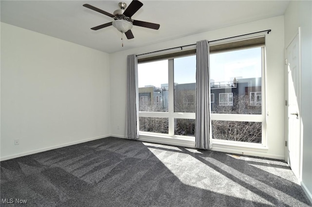1261 W 74, Cleveland, OH 44102 - spare room featuring dark colored carpet, baseboards, and a ceiling fan