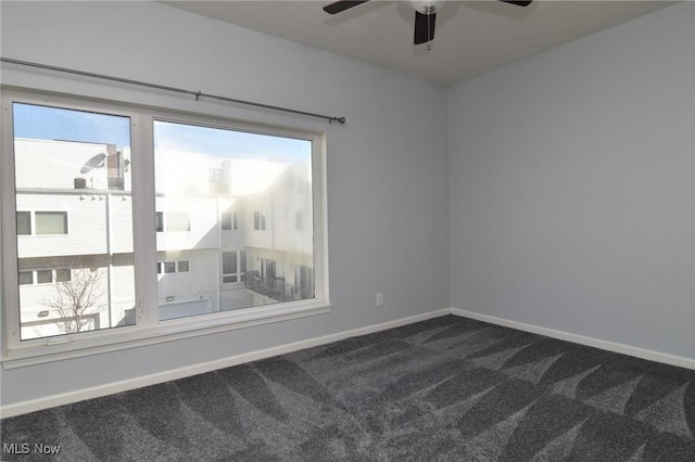 1261 W 74, Cleveland, OH 44102 - empty room with dark carpet, healthy amount of natural light, a ceiling fan, and baseboards