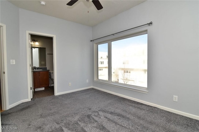 1261 W 74, Cleveland, OH 44102 - unfurnished bedroom featuring dark colored carpet, baseboards, a sink, connected bathroom, and ceiling fan
