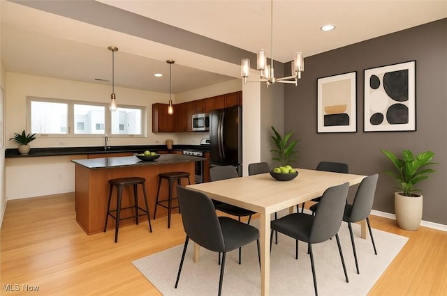 1261 W 74, Cleveland, OH 44102 - dining room featuring light wood-style floors, a chandelier, recessed lighting, and baseboards