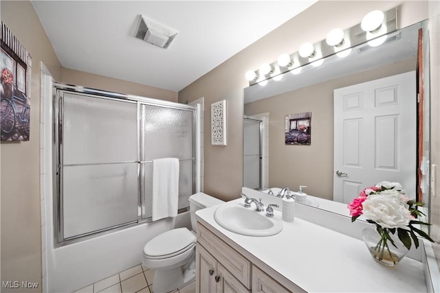 4100 Chagrin River Rd, Moreland Hills, OH 44022 - bathroom with vanity, tile patterned floors, bath / shower combo with glass door, and toilet