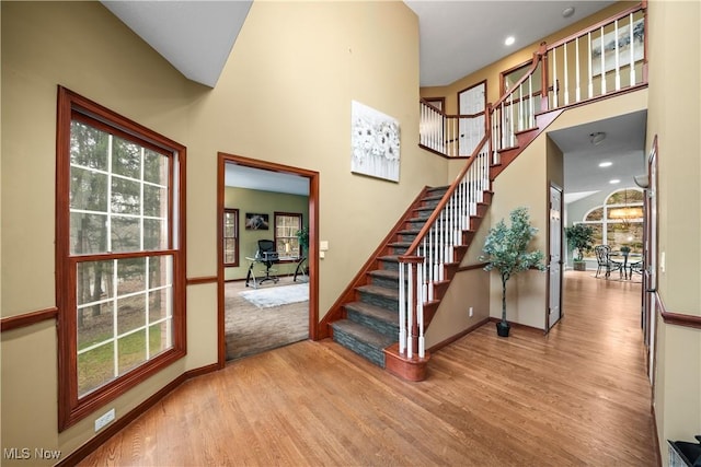 4100 Chagrin River Rd, Moreland Hills, OH 44022 - stairs featuring wood finished floors, baseboards, plenty of natural light, a high ceiling, and recessed lighting