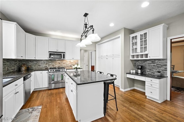 4100 Chagrin River Rd, Moreland Hills, OH 44022 - kitchen featuring stainless steel appliances, white cabinetry, decorative backsplash, a center island, and recessed lighting