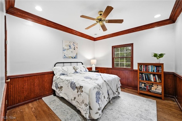 4100 Chagrin River Rd, Moreland Hills, OH 44022 - bedroom with a wainscoted wall, crown molding, wooden walls, wood finished floors, and ceiling fan