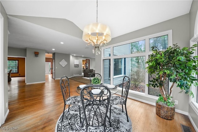4100 Chagrin River Rd, Moreland Hills, OH 44022 - dining space with light wood-style flooring, plenty of natural light, a chandelier, baseboards, and lofted ceiling