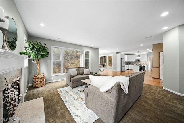 4100 Chagrin River Rd, Moreland Hills, OH 44022 - living room featuring a premium fireplace, recessed lighting, wood finished floors, and baseboards