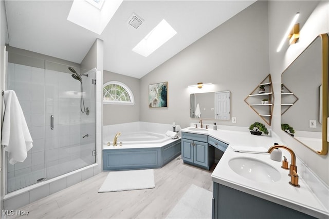 4100 Chagrin River Rd, Moreland Hills, OH 44022 - full bathroom with a skylight, a shower stall, lofted ceiling, a bath, and wood finished floors