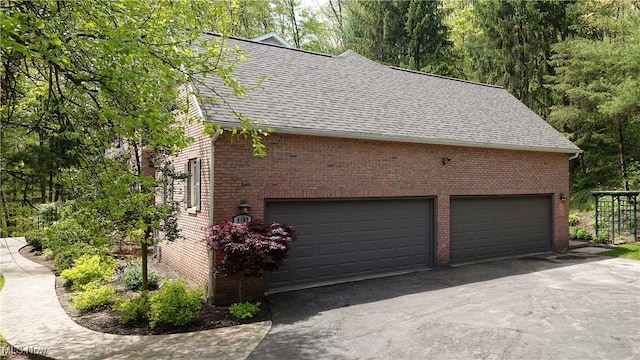 4100 Chagrin River Rd, Moreland Hills, OH 44022 - view of property exterior with roof with shingles, brick siding, and asphalt driveway