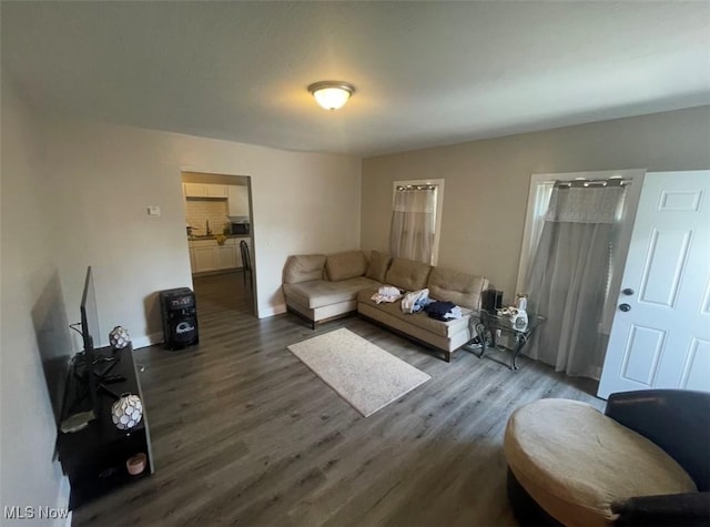 3782 W 38th St, Cleveland, OH 44109 - living room featuring dark wood-style flooring and baseboards