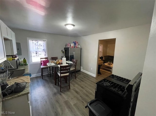 3782 W 38th St, Cleveland, OH 44109 - dining room with wood finished floors, baseboards, and electric panel
