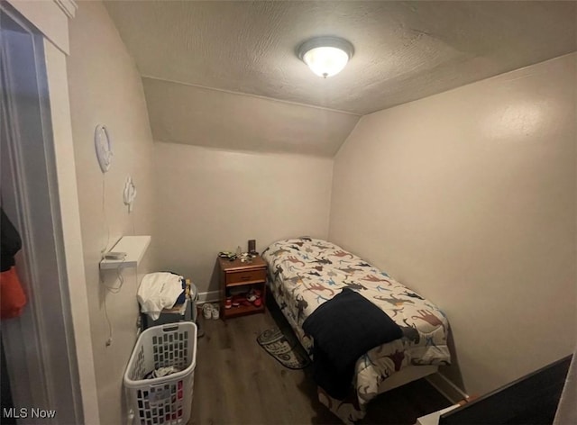 3782 W 38th St, Cleveland, OH 44109 - bedroom with wood finished floors, lofted ceiling, and a textured ceiling