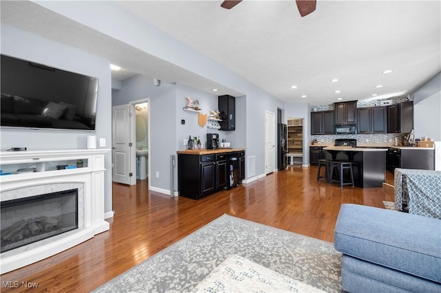 3186 Blackburn Ln, Brunswick, OH 44212 - living room featuring wood finished floors, a ceiling fan, recessed lighting, baseboards, and a fireplace