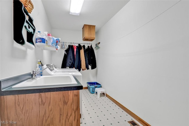 9620 Bimeler St NE, Bolivar, OH 44612 - bathroom featuring visible vents, baseboards, a sink, tile patterned floors, and independent washer and dryer
