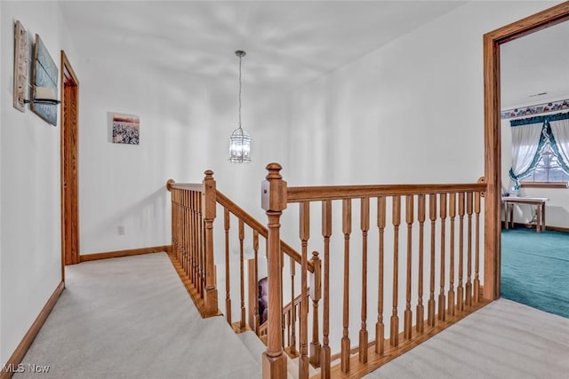 9620 Bimeler St NE, Bolivar, OH 44612 - hallway with carpet, an inviting chandelier, an upstairs landing, and baseboards