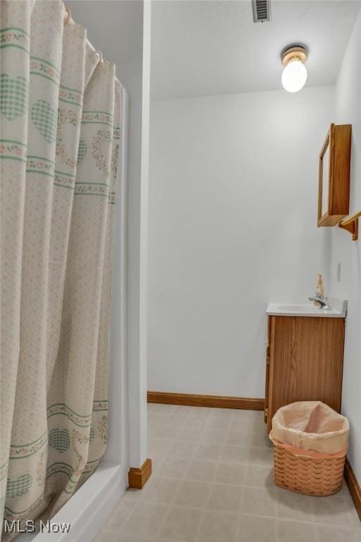 9620 Bimeler St NE, Bolivar, OH 44612 - bathroom featuring a shower with shower curtain, visible vents, baseboards, and vanity
