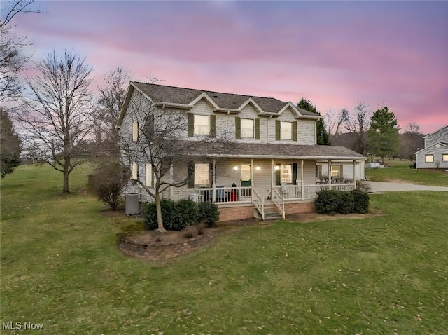 9620 Bimeler St NE, Bolivar, OH 44612 - view of front facade featuring covered porch, driveway, and a yard
